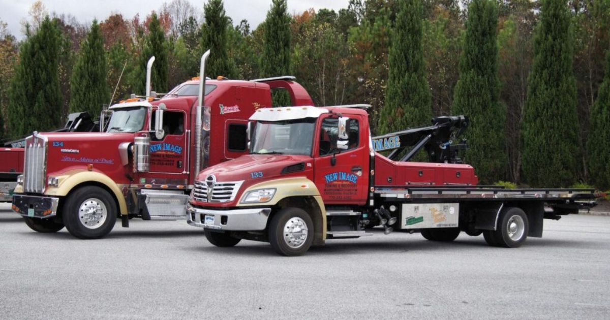 two tow trucks showing the difference between heavy duty towing benefits and light duty towing benefits